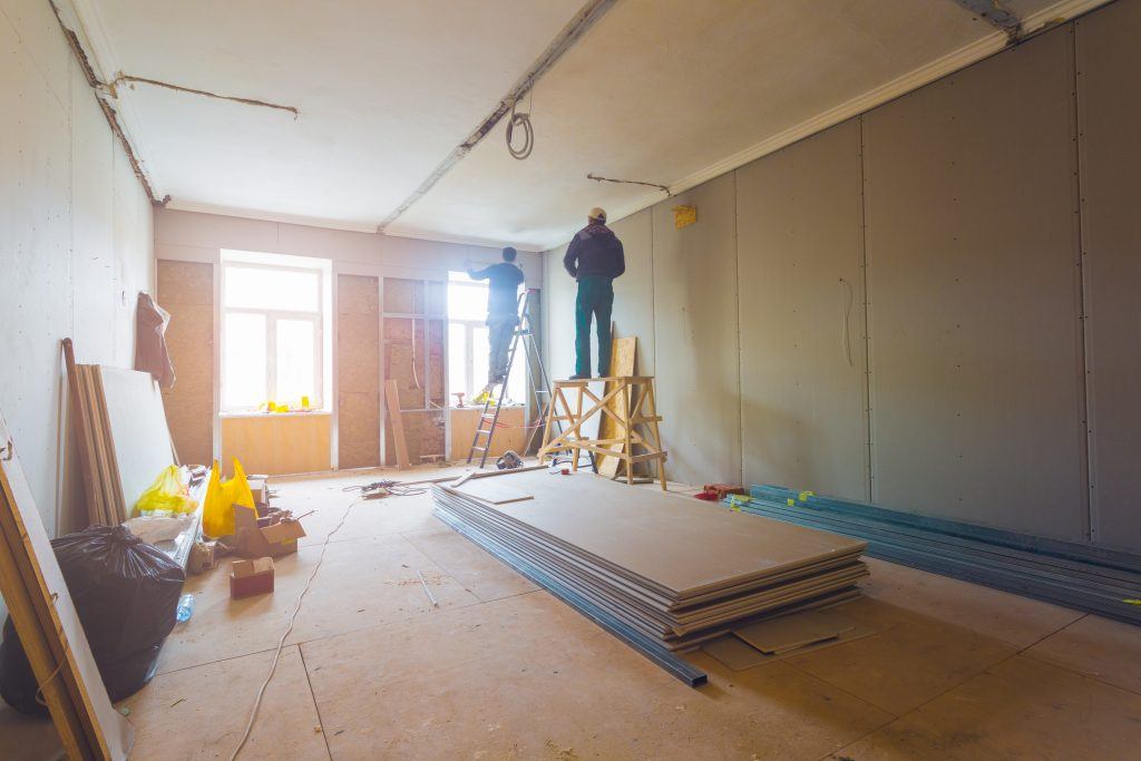 Workers are installing plasterboard